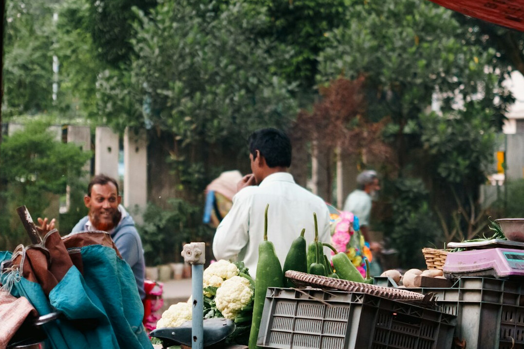 Vendor and customers at an outdoor community street market
